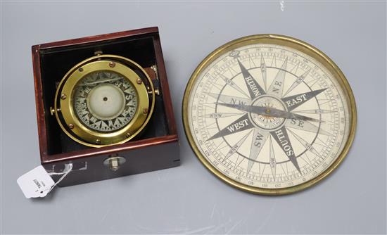 A marine compass on brass gimbal mount in mahogany case and a brass surveyors compass with 8in diameter card